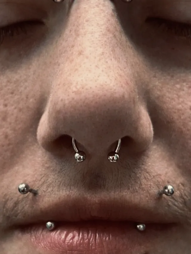 Double nostril and lower lip piercings by Sydney