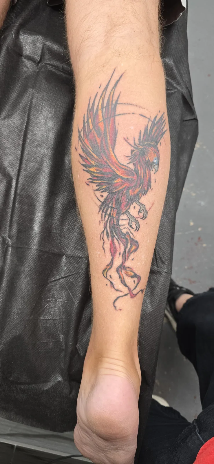 Fine line winged figure forearm tattoo by Joshua Key