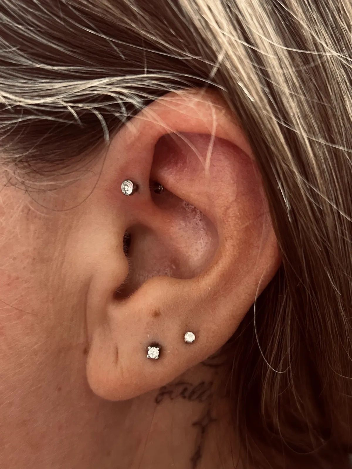 Helix and lobe piercings with gem studs by Sydney