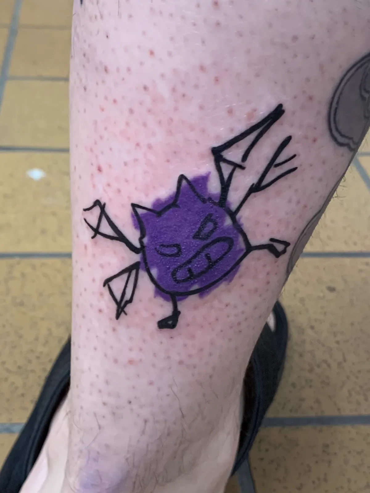 Purple cartoon bat leg tattoo by Sav