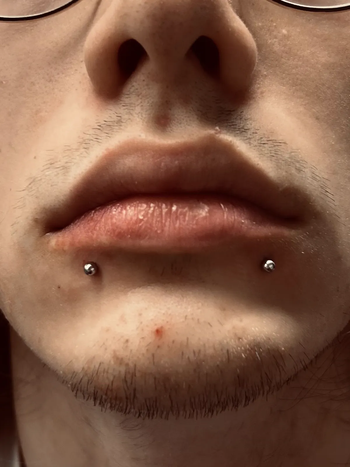 Double lip piercings with silver studs by Sydney