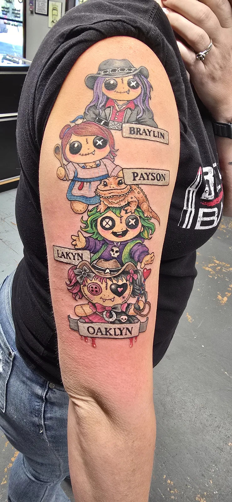 Colorful pop culture character sleeve tattoo by Joshua Key