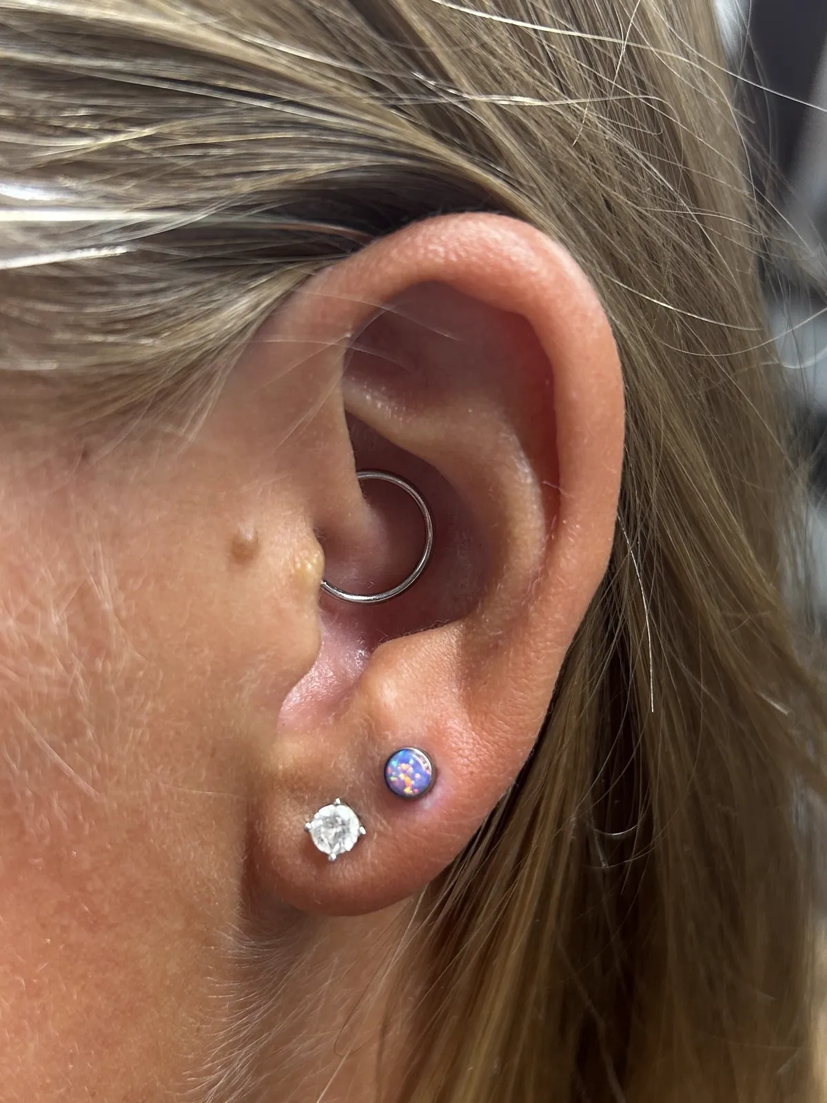 Daith and lobe piercings with gem jewelry by Sydney