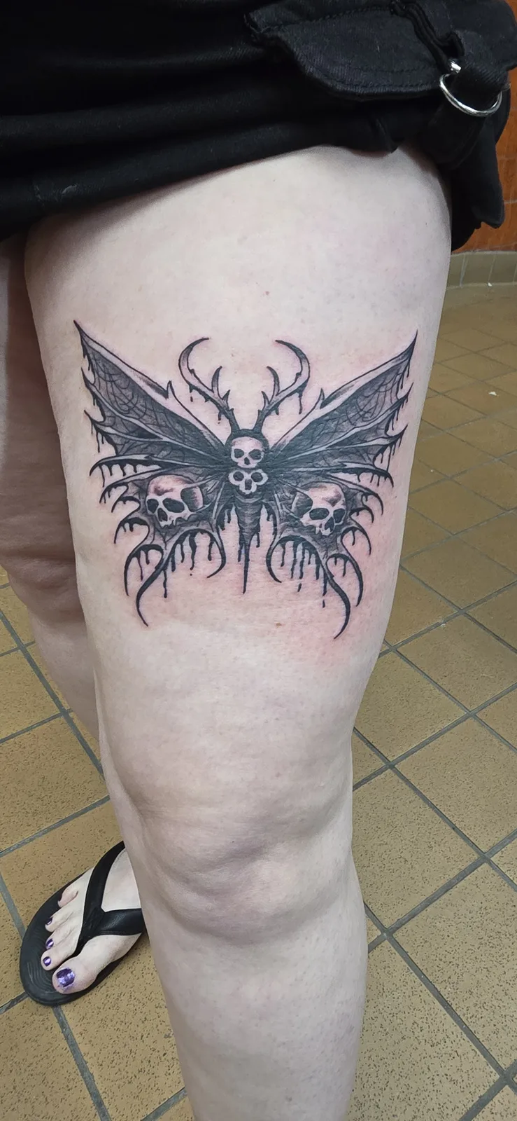 Blue moth thigh tattoo by Joshua Key