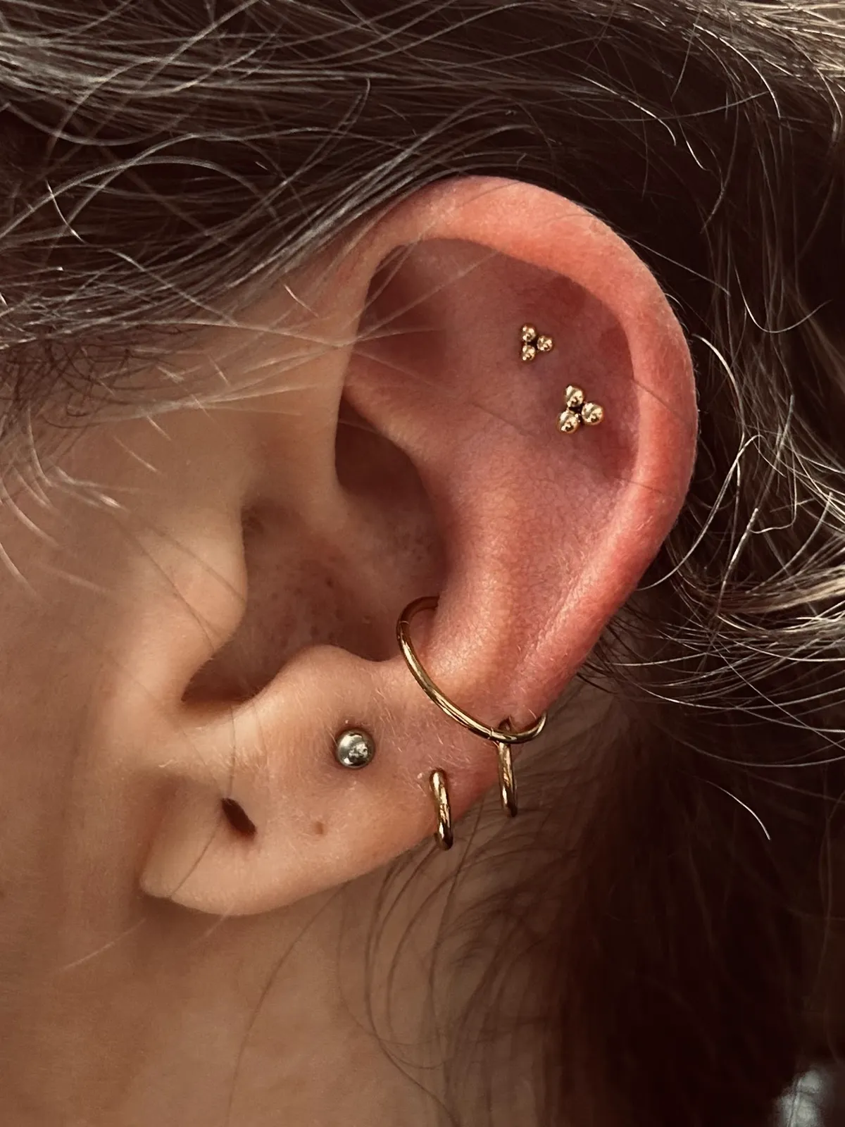 Conch hoop with forward helix piercings by Sydney