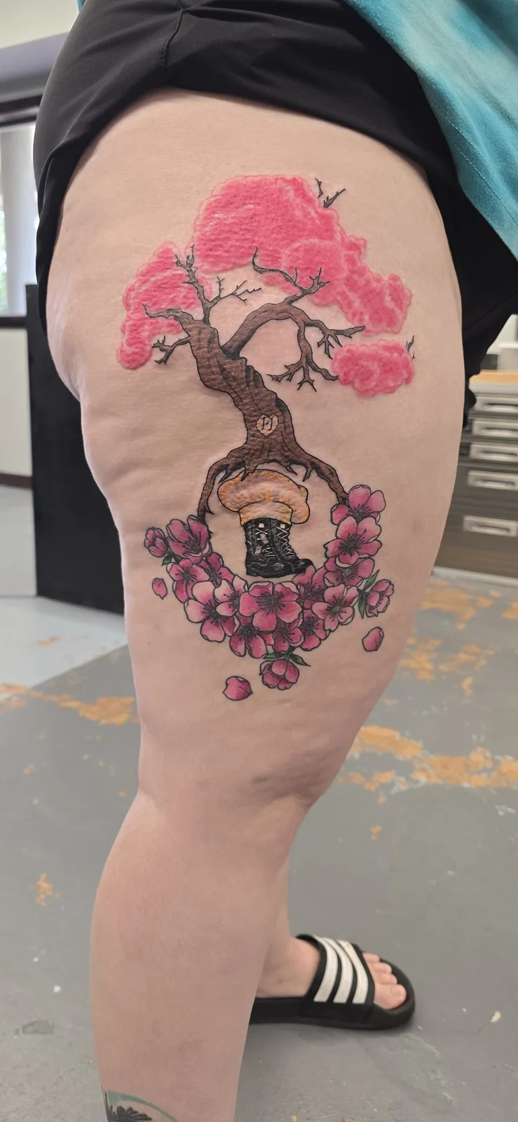 Pink cherry blossom tree leg tattoo by Joshua Key