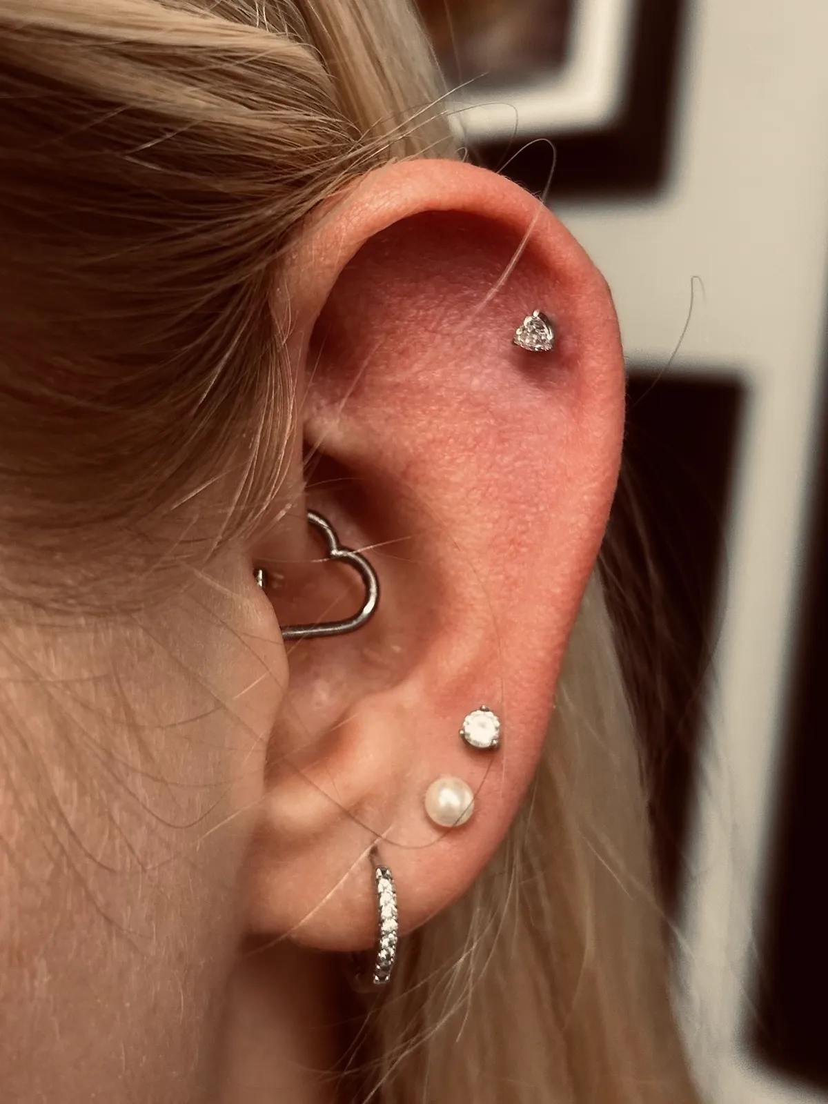 Rook piercing with heart jewelry and lobe stack by Sydney