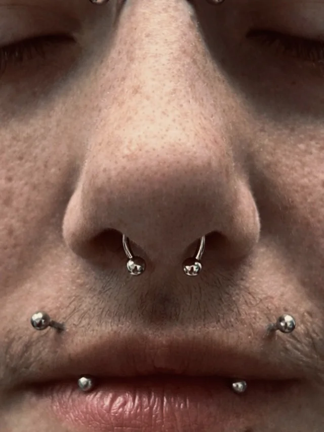 Symmetrical nose and lip piercings by Sydney